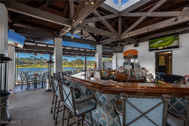 interior space featuring a gazebo, ceiling fan, and a bar