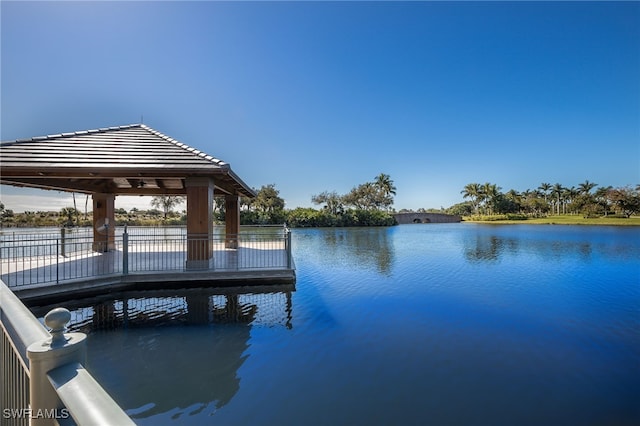 view of dock with a gazebo and a water view