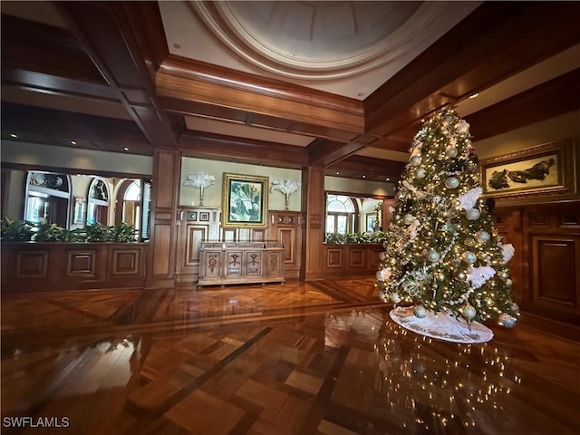 interior space featuring beamed ceiling, parquet flooring, coffered ceiling, and a notable chandelier