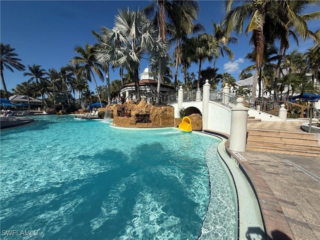 view of swimming pool with pool water feature