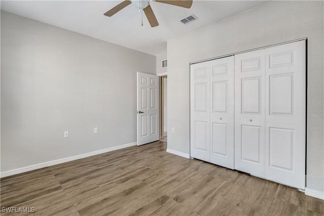 unfurnished bedroom featuring ceiling fan, a closet, and light hardwood / wood-style floors