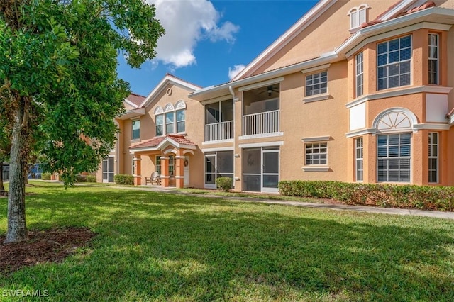 rear view of property with a yard