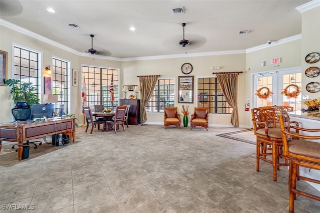 living room featuring crown molding, ceiling fan, and a healthy amount of sunlight