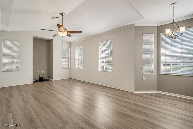 unfurnished living room featuring ceiling fan with notable chandelier, vaulted ceiling, a wealth of natural light, and light hardwood / wood-style flooring