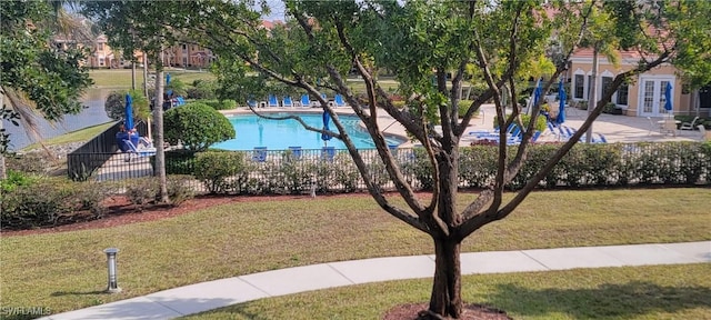 surrounding community with a pool and a yard