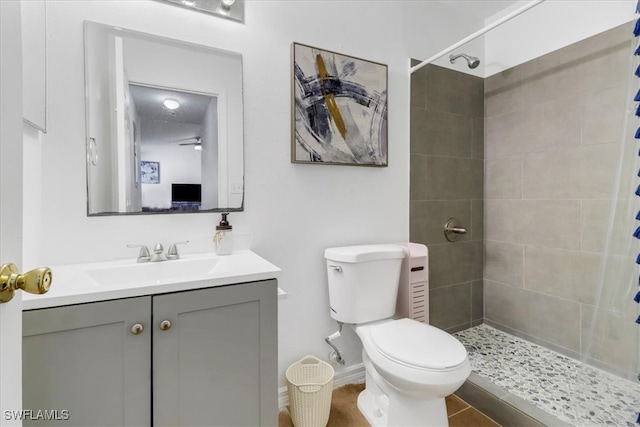 bathroom featuring a shower with curtain, tile patterned floors, vanity, and toilet