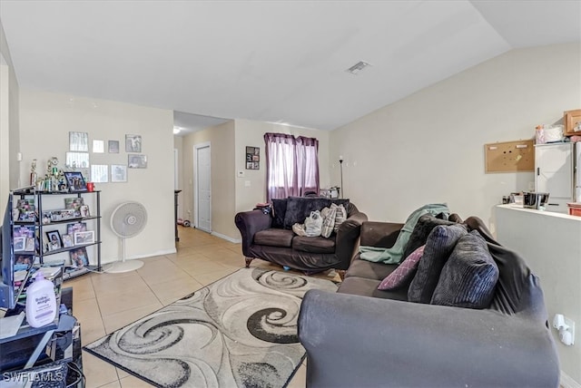 living room featuring a healthy amount of sunlight, light tile patterned floors, and vaulted ceiling