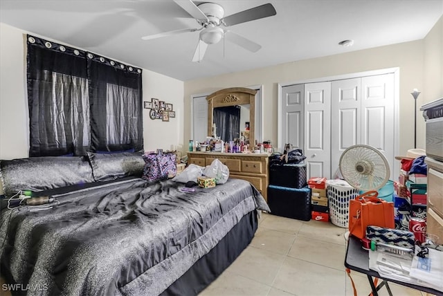 bedroom featuring a closet, ceiling fan, and light tile patterned flooring