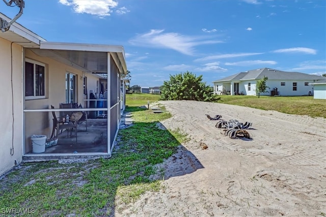 view of yard featuring a sunroom