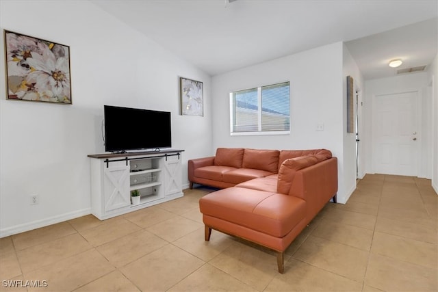 living room with vaulted ceiling and light tile patterned flooring