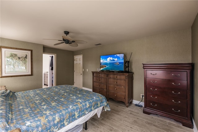 bedroom featuring connected bathroom, ceiling fan, and light hardwood / wood-style floors