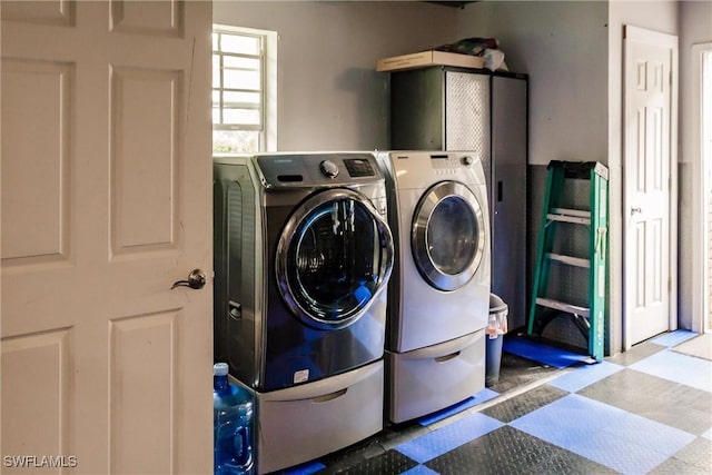 clothes washing area with tile patterned floors, laundry area, and separate washer and dryer