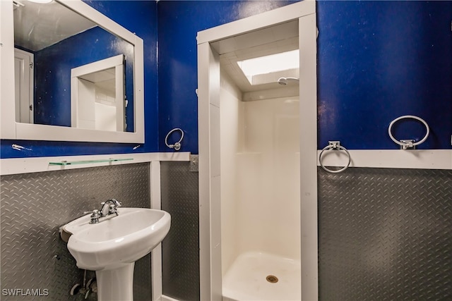 bathroom featuring a shower and sink