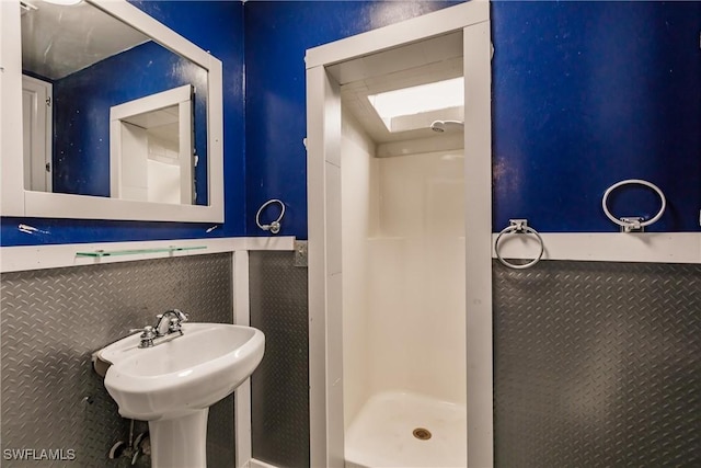 bathroom featuring a shower stall and a sink