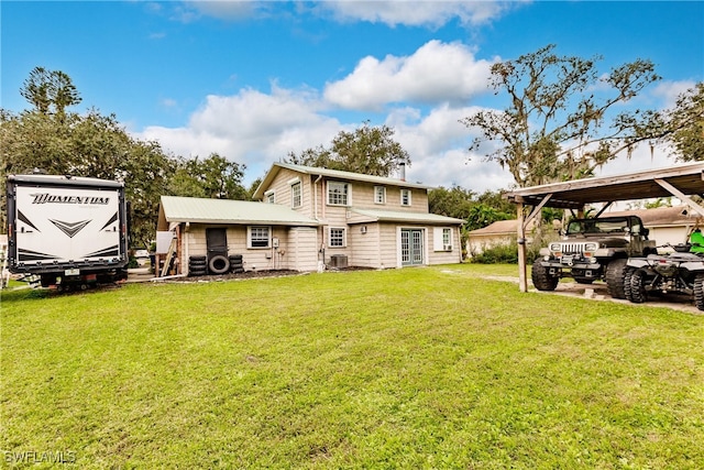 rear view of house with a yard and a carport