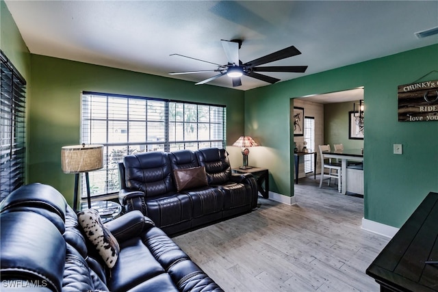 living room featuring ceiling fan and light hardwood / wood-style floors