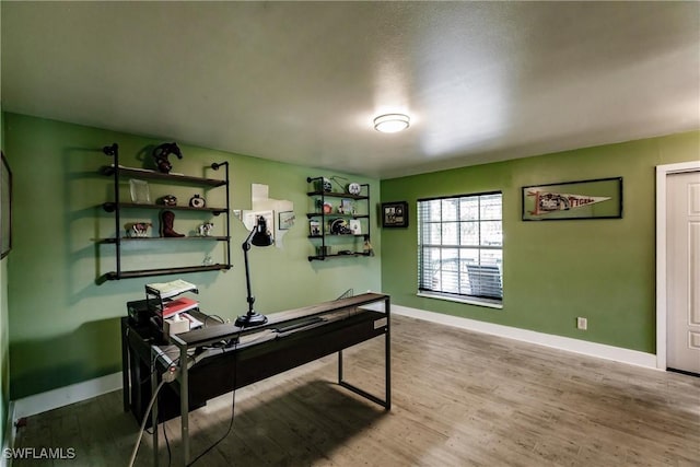 office space with baseboards and wood finished floors