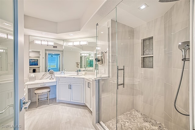 bathroom featuring vanity and an enclosed shower