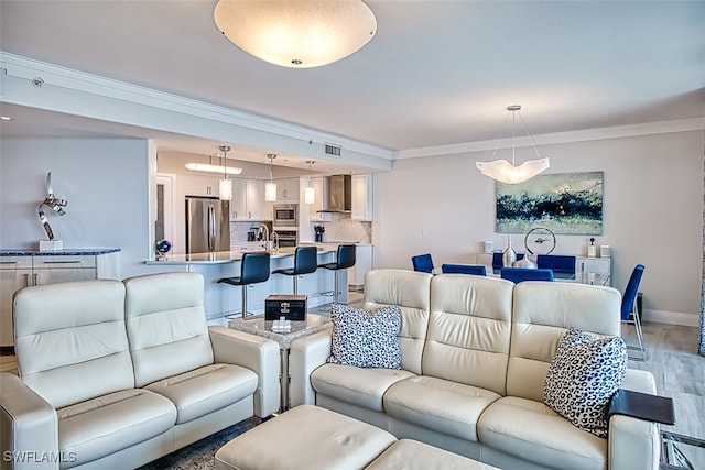 living room featuring hardwood / wood-style floors and crown molding