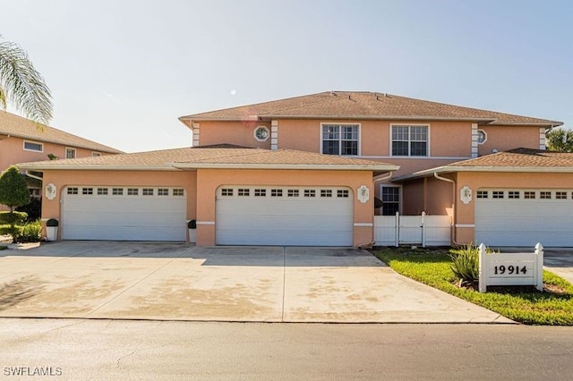 19914 Lake Vista Cir N Unit 2, Lehigh Acres, FL 33936 - view of front of house with concrete driveway, an attached garage, and stucco siding
