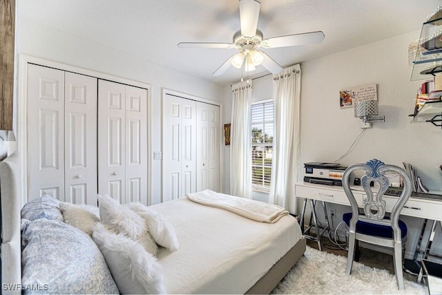 bedroom featuring ceiling fan and two closets