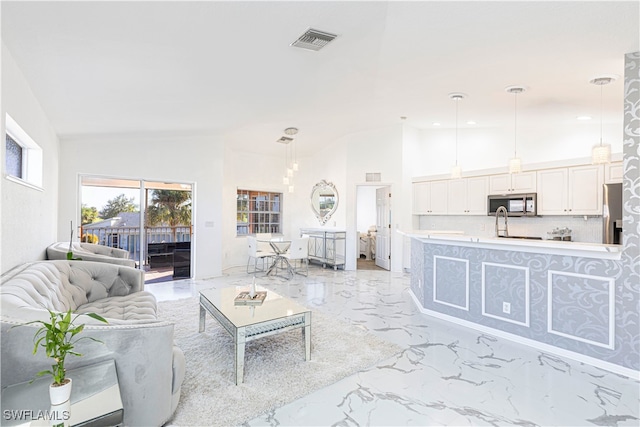 living room with high vaulted ceiling