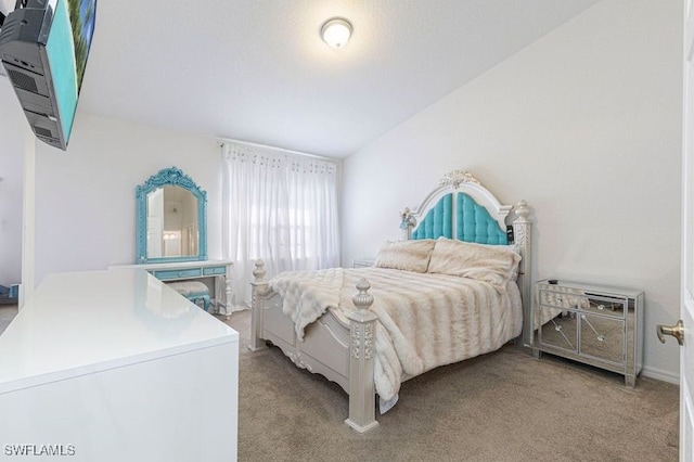 bedroom featuring vaulted ceiling and light carpet