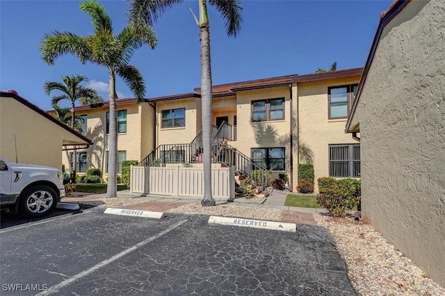 5103 Sunnybrook Ct Unit 3, Cape Coral, FL 33904 - view of front facade featuring uncovered parking, stucco siding, and stairs