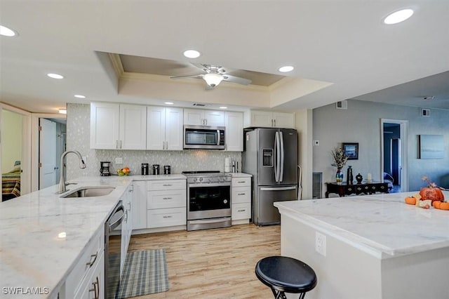 5103 Sunnybrook Ct Unit 3, Cape Coral, FL 33904 - kitchen with appliances with stainless steel finishes, a sink, a raised ceiling, recessed lighting, and white cabinets