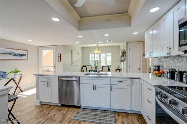 5103 Sunnybrook Ct Unit 3, Cape Coral, FL 33904 - kitchen with stainless steel appliances, a sink, a raised ceiling, a peninsula, and recessed lighting