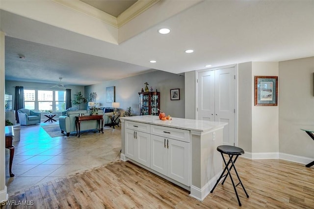 5103 Sunnybrook Ct Unit 3, Cape Coral, FL 33904 - kitchen featuring ornamental molding, recessed lighting, a center island, white cabinetry, and open floor plan