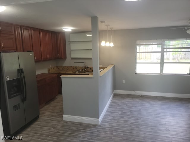 kitchen featuring ceiling fan, stainless steel fridge with ice dispenser, hanging light fixtures, and dark wood-type flooring