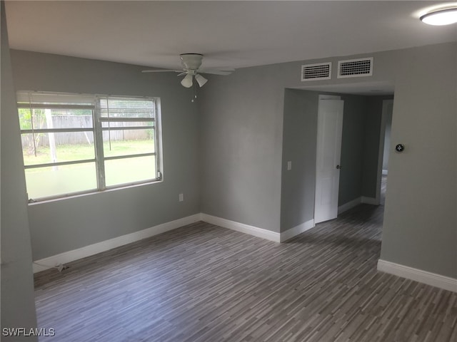 empty room featuring ceiling fan and dark wood-type flooring