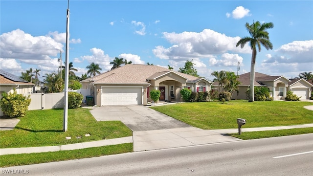 view of front of property with a garage and a front lawn