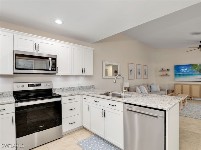 kitchen with kitchen peninsula, white cabinets, and stainless steel appliances