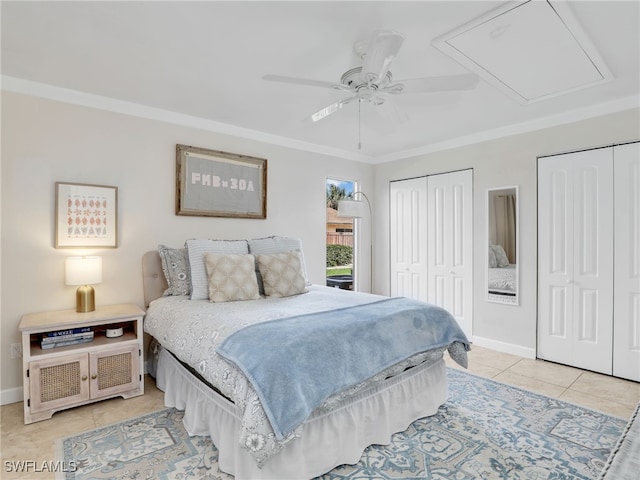 tiled bedroom with two closets, ceiling fan, and crown molding