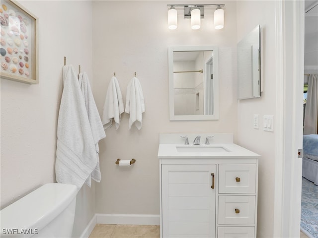 bathroom featuring tile patterned floors, vanity, and toilet