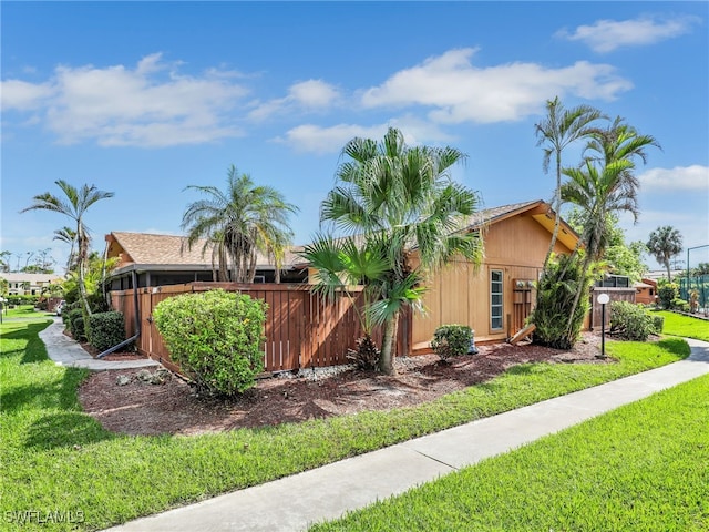 view of side of property with a yard