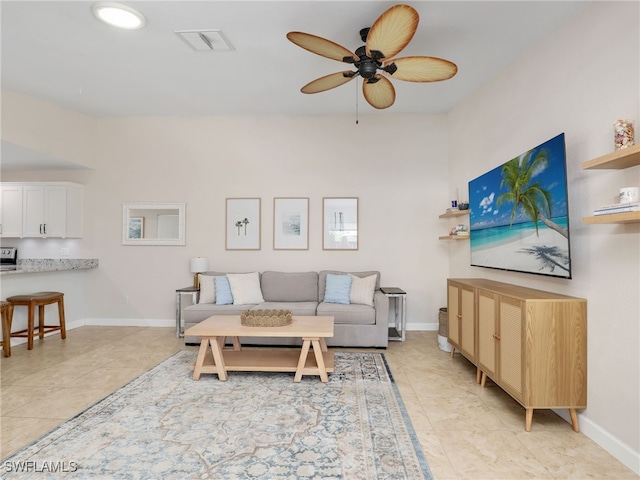 tiled living room featuring ceiling fan