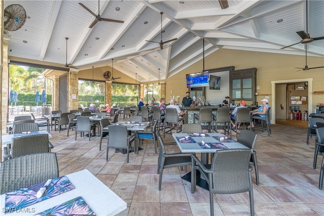 dining area featuring ceiling fan, beamed ceiling, high vaulted ceiling, and wooden ceiling