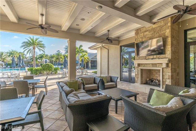 view of patio featuring an outdoor living space with a fireplace and ceiling fan