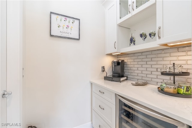 bar featuring white cabinets and beverage cooler