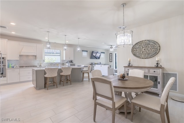 dining area featuring ceiling fan and heating unit