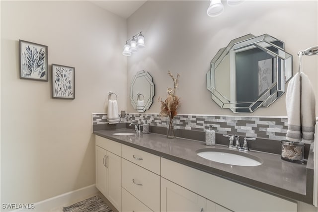 bathroom featuring decorative backsplash and vanity