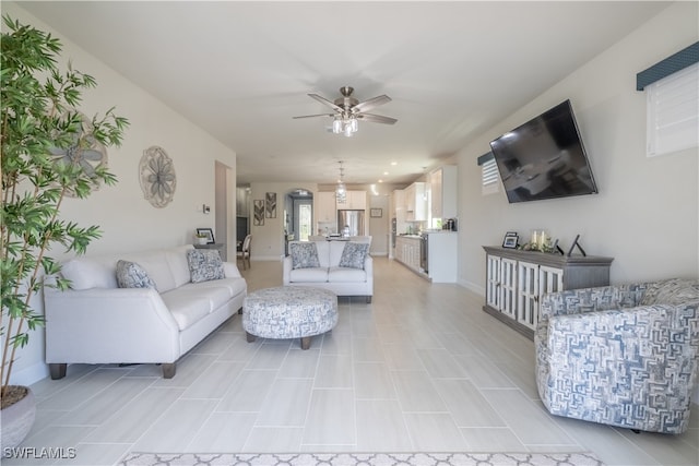 tiled living room with ceiling fan