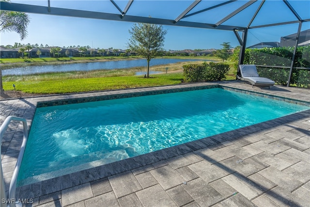 view of swimming pool featuring a lanai, a water view, and a patio