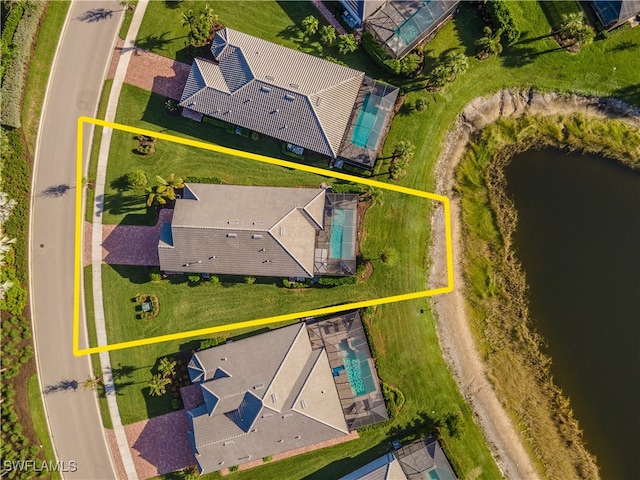 birds eye view of property with a water view