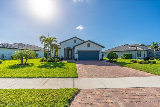 single story home with a garage and a front lawn