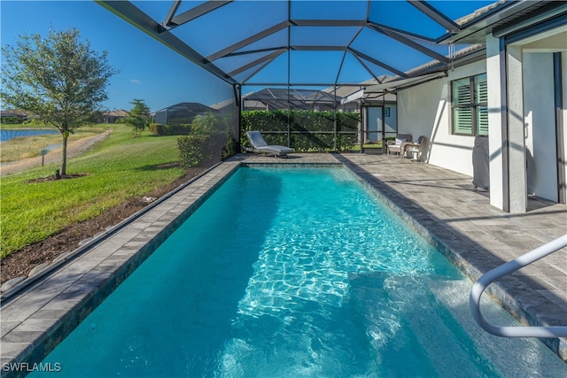 view of swimming pool with a lawn, a lanai, and a patio