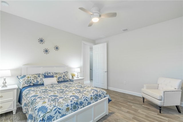 bedroom with light hardwood / wood-style floors and ceiling fan